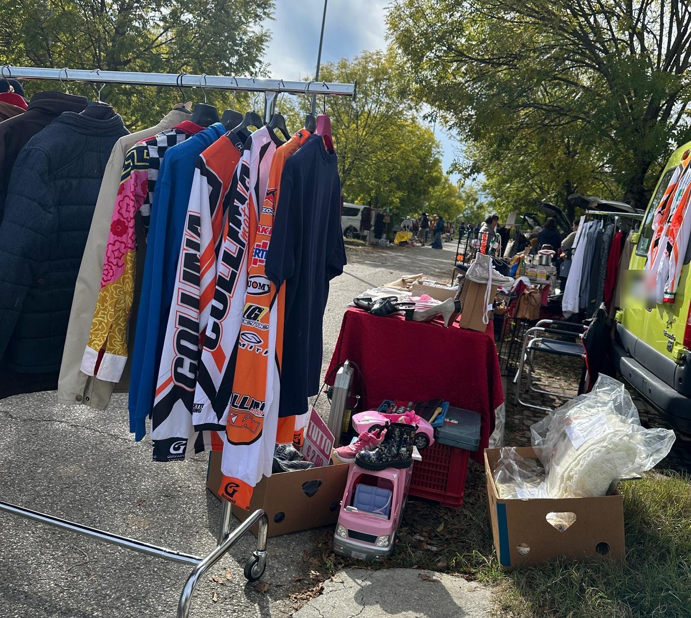 Uno stendino di giacche e maglie da motocross, e in fondo il viale con le altre postazioni